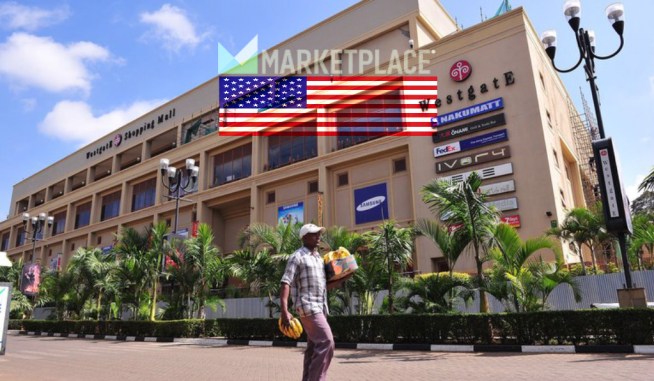 A man carries bananas past the Westgate Shopping Centre in Nairobi. A year after a devastating terrorist attack, the mall is to reopen partially. SIMON MAINA/AFP/Getty Images